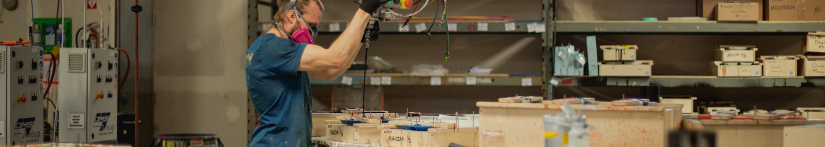 A Proxy employee pouring polyurethane plastic into a climbing hold mold.