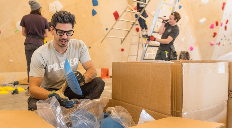 A route setter selecting climbing holds.