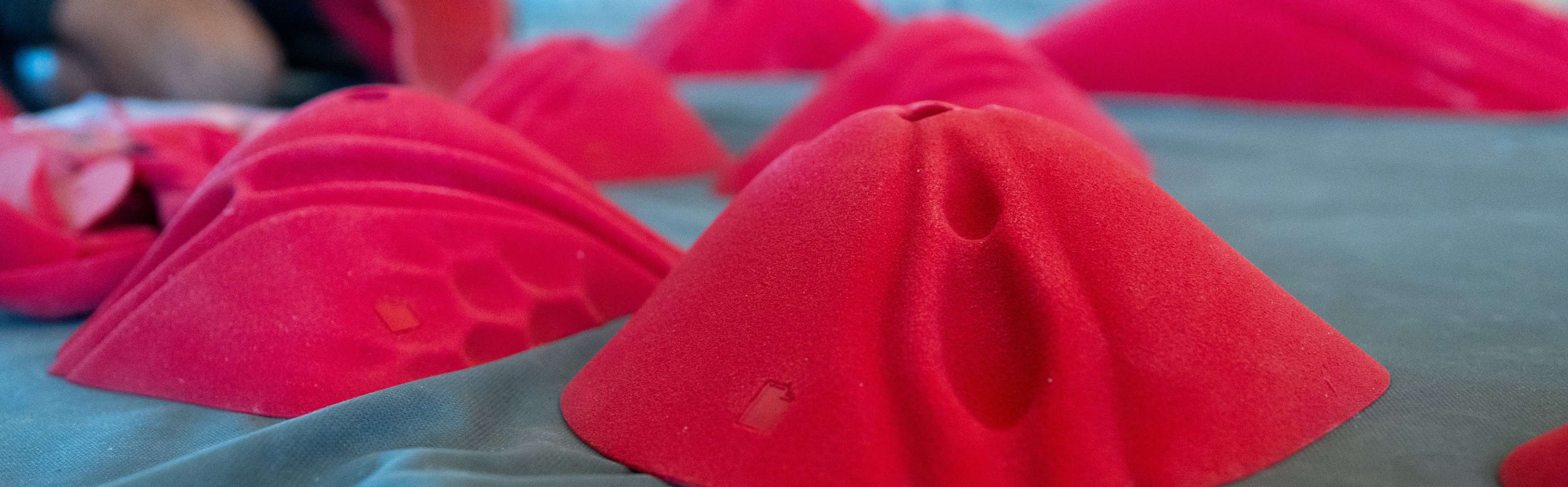 Red Sugarhouse climbing holds on a mat